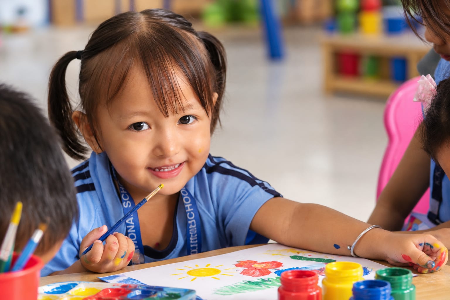 KKIS student enjoying a painting activity